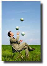 man juggling earth globes